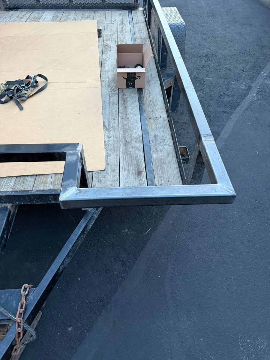 New bare-steel extension framing welded onto the original trailer frame